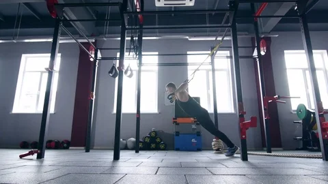 Man making trx lunge press exersices Stock Footage 73994832