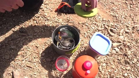 A man making Turkish coffee  on a camping stove outdoor Stock Footage 139496599