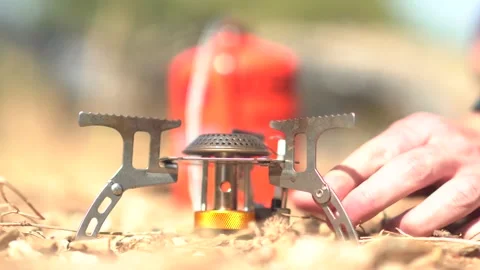 A man making Turkish coffee  on a camping stove outdoor Stock Footage 139496615