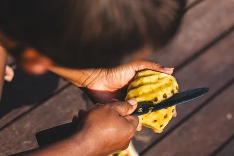 Man Making Unique Pineapple Cuts. Precision and Creativity. Stock Photos