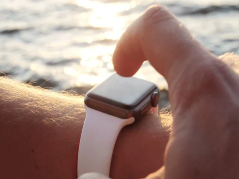 Man making various gestures with a finger on a touch screen of a smart watch wea Vídeo Stock 79980080