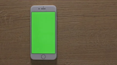 Man making various gestures on the green screen of a phone at home Stock Footage 142889822