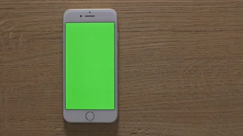 Man making various gestures on the green screen of a phone at home Stock Footage 142896000