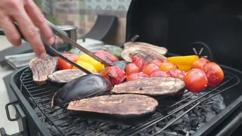 The man is making  vegetables on the barbecue Stock Footage 159329836
