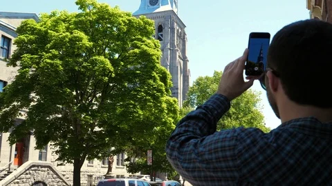 Man making a video of fluff flying in the air. Stockbeeldmateriaal 116279339