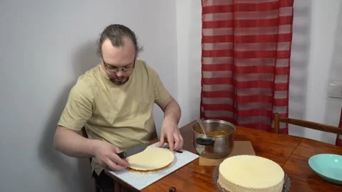 A man is making a waffle cake with condensed milk. Sweet food. Stock Footage 331936580