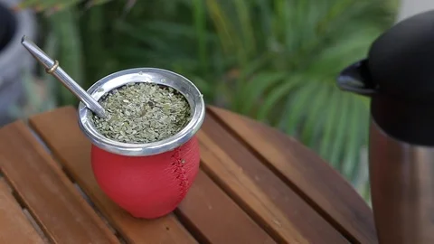 Man making yerba mate tea. Close up pouring hot water into traditional Mate cup. Stock Footage 127796336