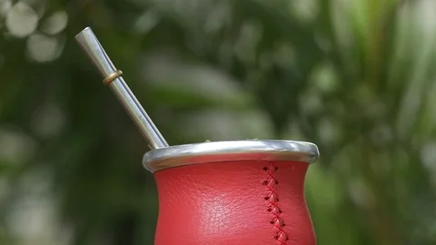 Man making yerba mate tea. Close up pouring hot water into traditional Mate cup. Stock Footage 127796433