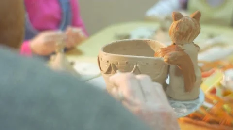 Man Male Hands Close Up Are Painting a Clay Pot Cat Figurine Glazing Pot by Stock Footage 59136236