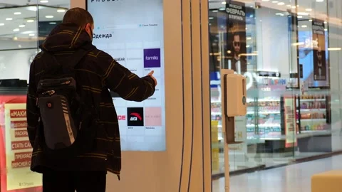 A man in a mall uses an information board. Russia Moscow 22.02.2022 Stock Footage 170743127