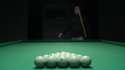 A man a man is about to break a pyramid of white billiard balls. The beginning Stock Footage 146807651