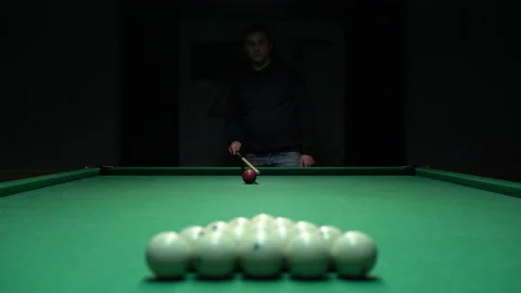 A man a man is about to break a pyramid of white billiard balls. The beginning Stock Footage 146807967