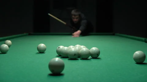 A man a man breaks a pyramid of white billiard balls. Start playing Russian Stock Footage 146808321