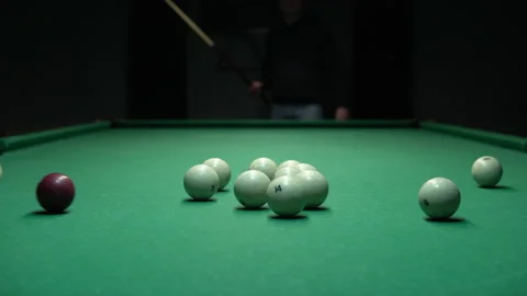 A man a man breaks a pyramid of white billiard balls. Start playing Russian Stock Footage 146808459