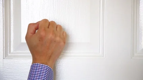 A man man hand knocking the door Stock Footage 129176499