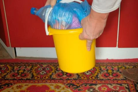 Man Man Preparing In Bucket Garbage To Take Out In Trash Cans Bucket Yellow Stock Photos