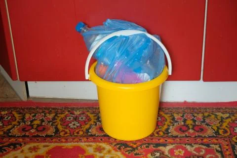 Man Man Preparing In Bucket Garbage To Take Out In Trash Cans Bucket Yellow Stock Photos
