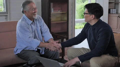 Man manager talking about insurer and consulting adult male customer with lap Stock Footage