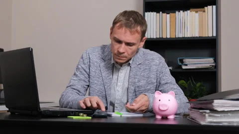 Man managing finances and counting coins Stock Footage 294883357