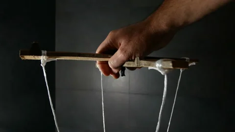 Man Maneuver in the Dark Pulling String Marionette Stock Footage 142834317