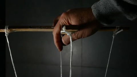 Man Maneuver in the Dark Pulling String Marionette Stock Footage 142834486