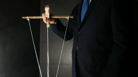 Man Maneuver in the Dark Pulling String Marionette Stock Footage 142834887