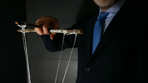 Man Maneuver in the Dark Pulling String Marionette Stock Footage 142835143