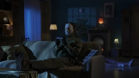 Man maniac sitting on the sofa in the someones living room, legs up on the table Stock Footage 250009109