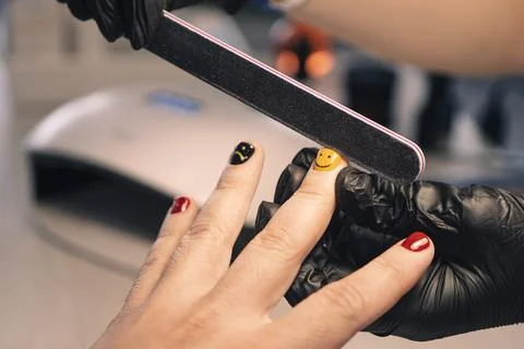 Man manicure. The process of coloring nails on men's fingers in a beauty salo Stock Photos