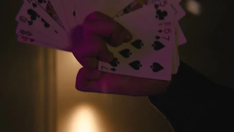 A man manipulates a deck of cards Stock Footage 141976374