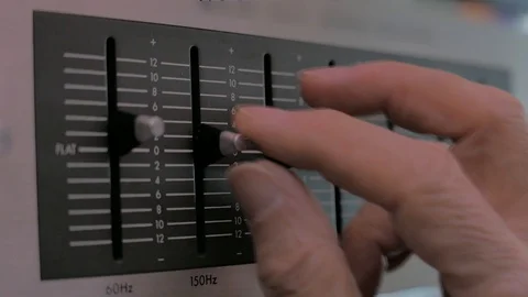 A man manipulates the sliding settings of an equalizer Stock Footage 100391680