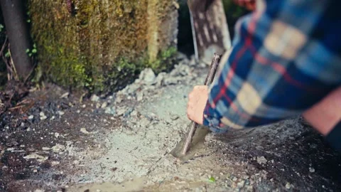 Man Manually Breaking Concrete Surface With Metal Digging Bar Stock Footage 346569127