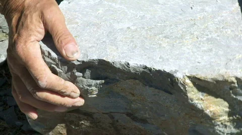 Man manually processing a stone in the quarry Stock Footage