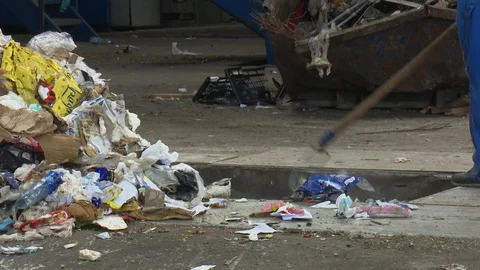 The man manually selects the waste at the landfill hall Stock Footage 121998921