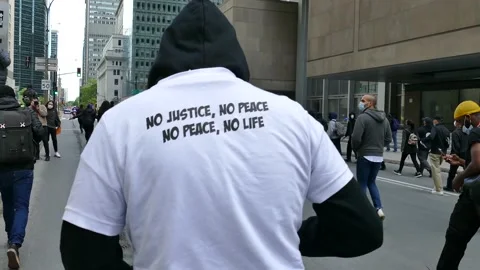 Man marching during protest with "no justice, no peace shirt" Stock Footage 132478338