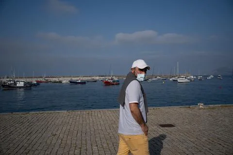 A man in marina, in summer at sunset. Stock Photos