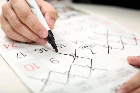 Man is marking on the calendar Stock Photos