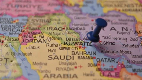 Man Marking Kuwait Location with Blue Pin on Paper World Map Stock Footage 333577826