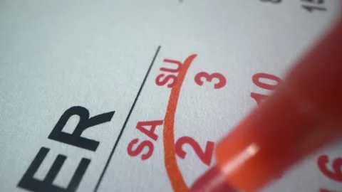 Man marks dates of weekend in calendar 2021. Macro shot. Plans for holidays Stock Footage 141369146