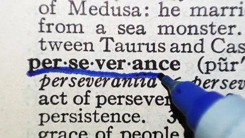 A man marks the definition from the word perseverance on a printed page with a p Vídeo Stock 297282634