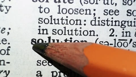 A man marks the word solution definition on a printed page with a pencil Vídeo Stock 297282860