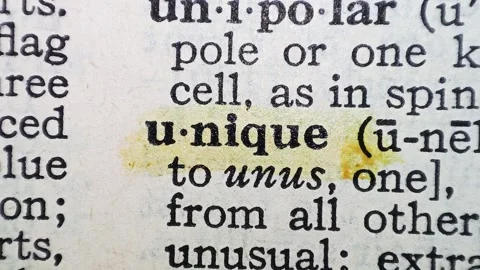 A man marks the word unique definition on a printed page with a marker pen Vídeos de archivo 297282863