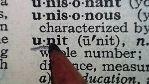 A man marks the word unit definition on a printed page with a pencil Vídeo Stock 297282843