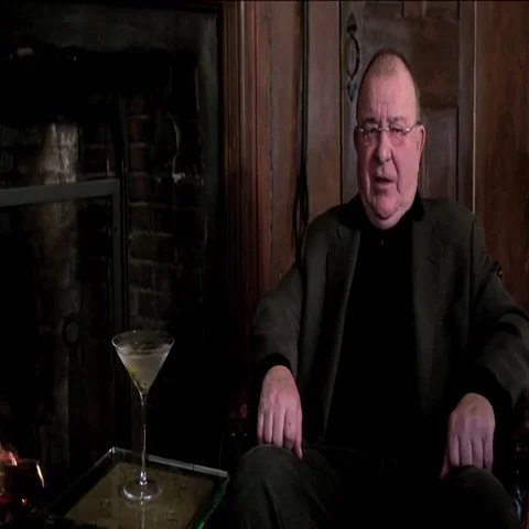Man with Martini by Fireplace Stock Footage 69715947