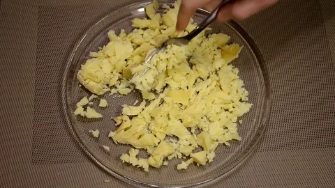 Man mashes potatoes Stock Footage 87598385
