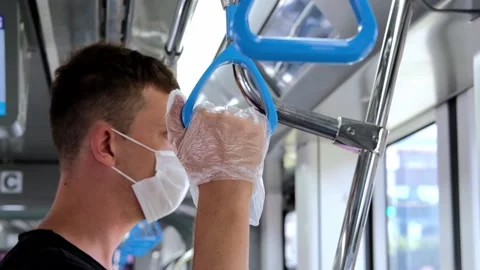 A man in a mask and protective gloves in transport. Covid-19 face mask Stock Footage 142266658
