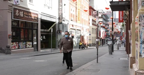Man in Mask Crosses Empty Street in Chinatown COVID 19 Coronavirus Stock Footage 128939668