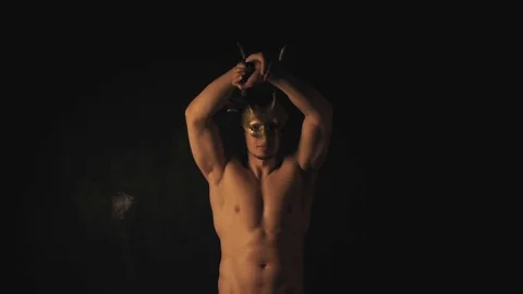 Man in mask on dark background Stock Footage 100245820