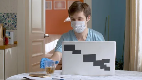 Man in mask drinking tea Stock Footage 127079976