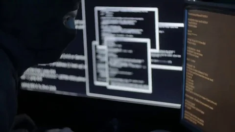 Man in a Mask Hacking a Computer System Stock Footage 69108147